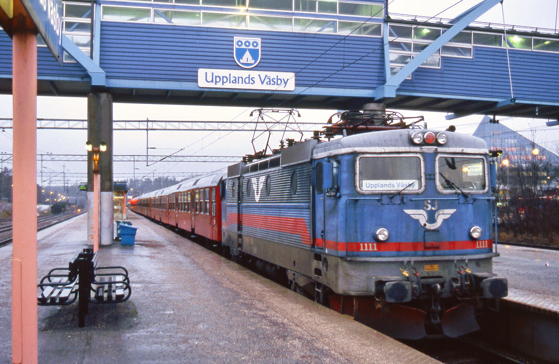 Bild: Rc2 1111 med ett pendeltåg bestående av Bn-vagnar i Upplands Väsby 2002